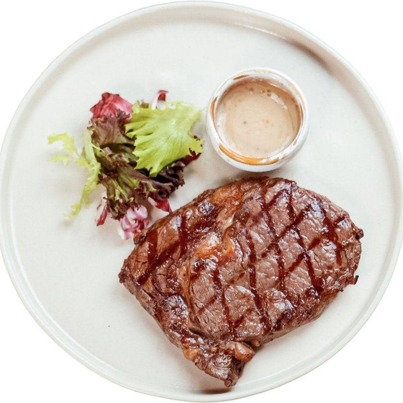 Pork steak in mustard marinade with greens