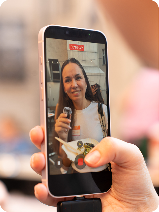 A guest being filmed on a phone at a Beyond Benefits evening
