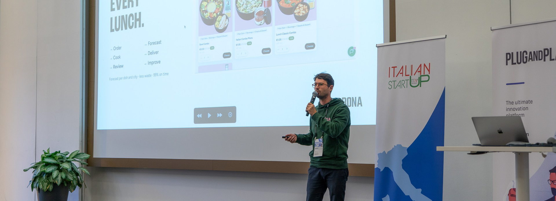 Niccolò Lapini presenting Bella&Bona at the ITA Demo Day in front of the "Tech behind every lunch" slide