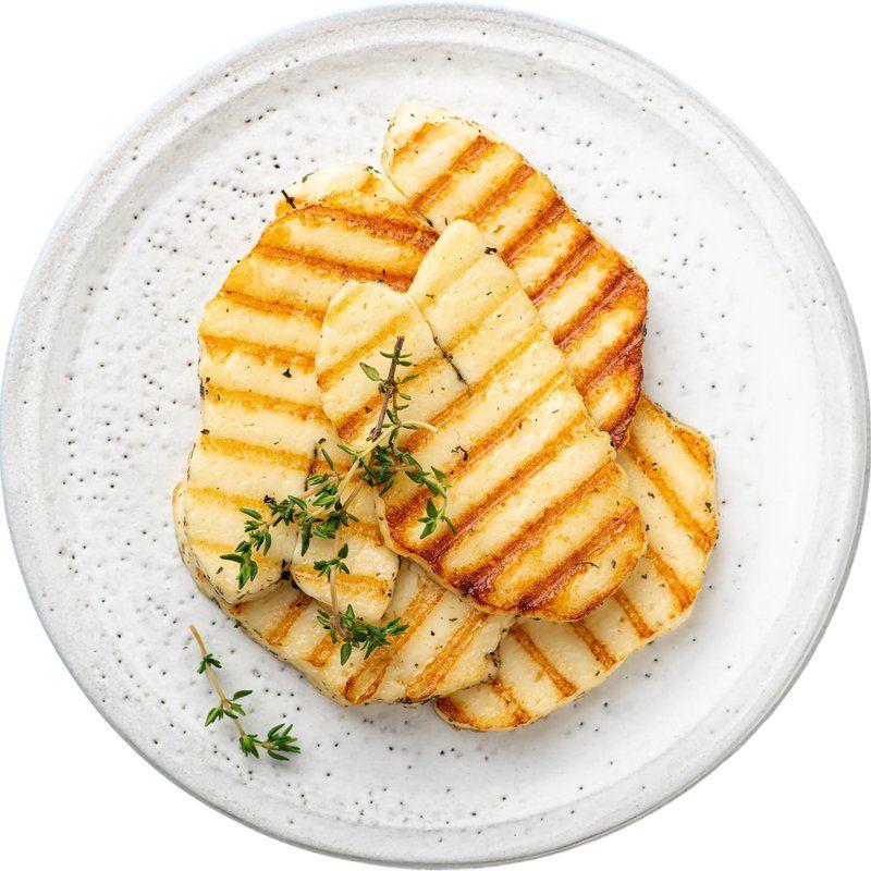 Grilled halloumi with fresh thyme on a plate