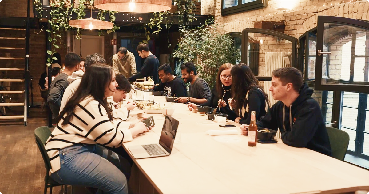Atolls employees sharing lunch at a long table in their Berlin office