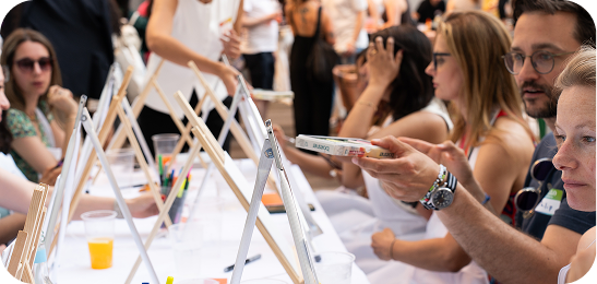 Guests painting at easels during a workshop