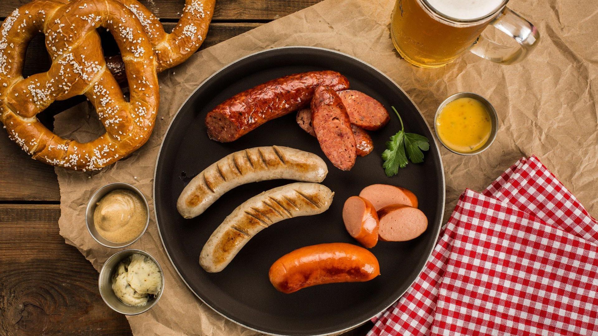 Bavarian pretzel and sausage plate served with beer