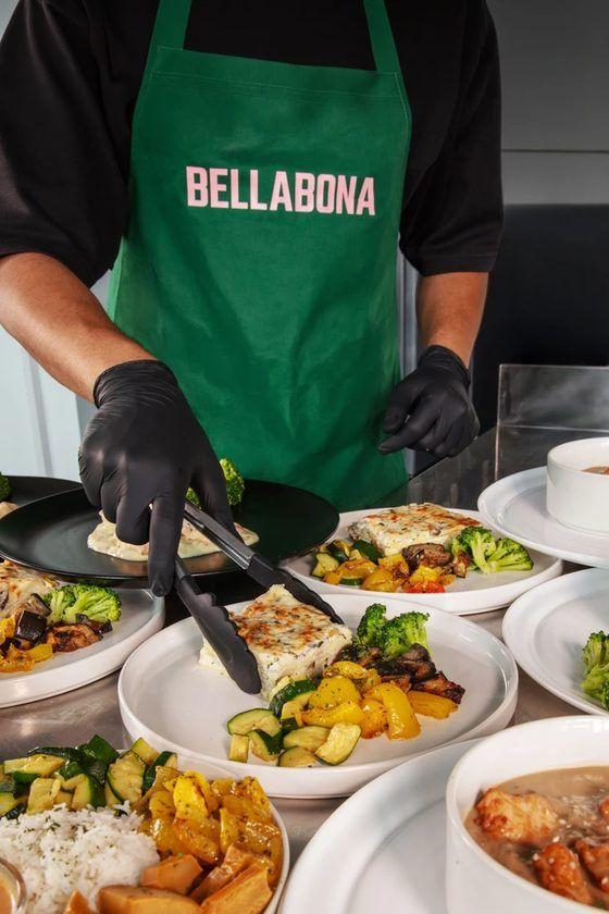 A chef plating fresh meals at an office pop-up restaurant