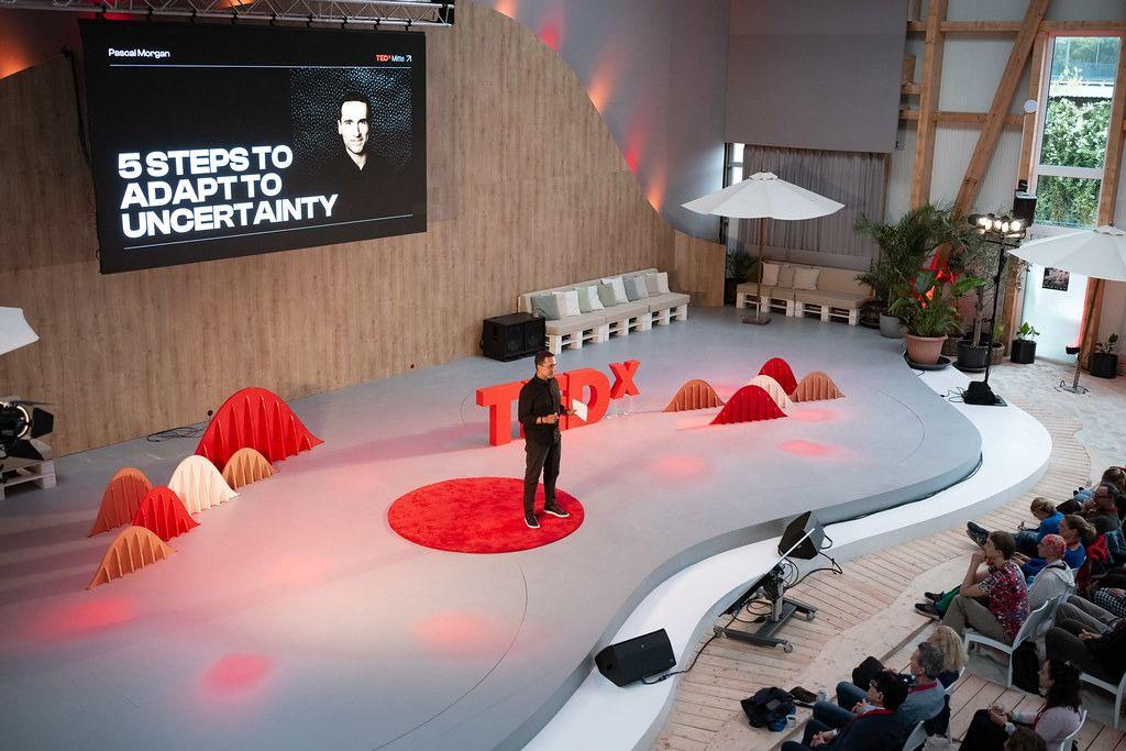 Aerial view of the TEDxMitte stage with the red TEDx carpet and audience