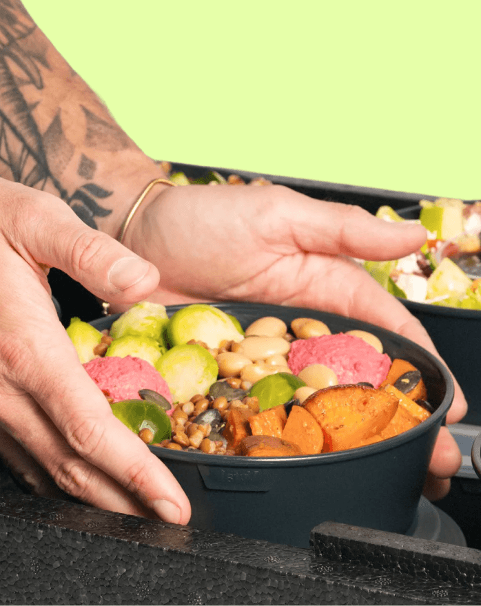 Hands holding a fresh Bella&Bona bowl