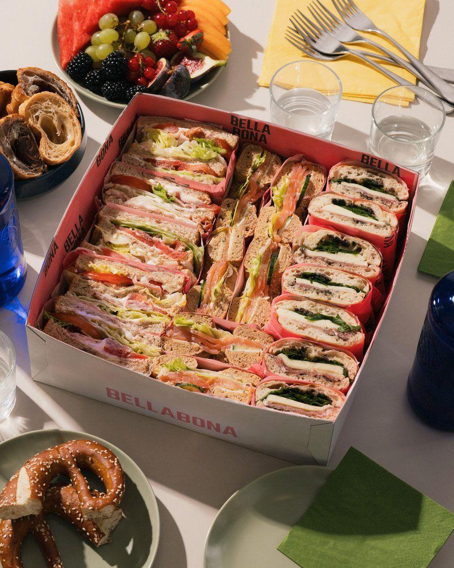 A catering box filled with fresh sandwiches and wraps