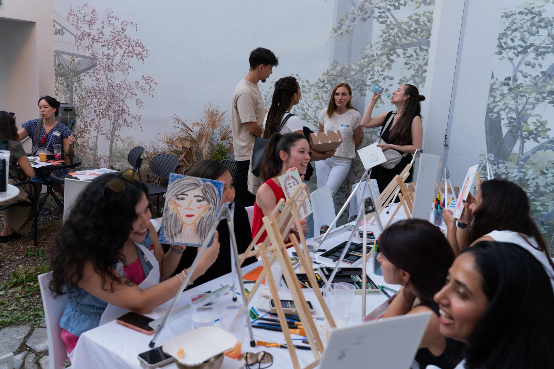 Guests taking part in PaintNow's speed portrait session at Beyond Benefits