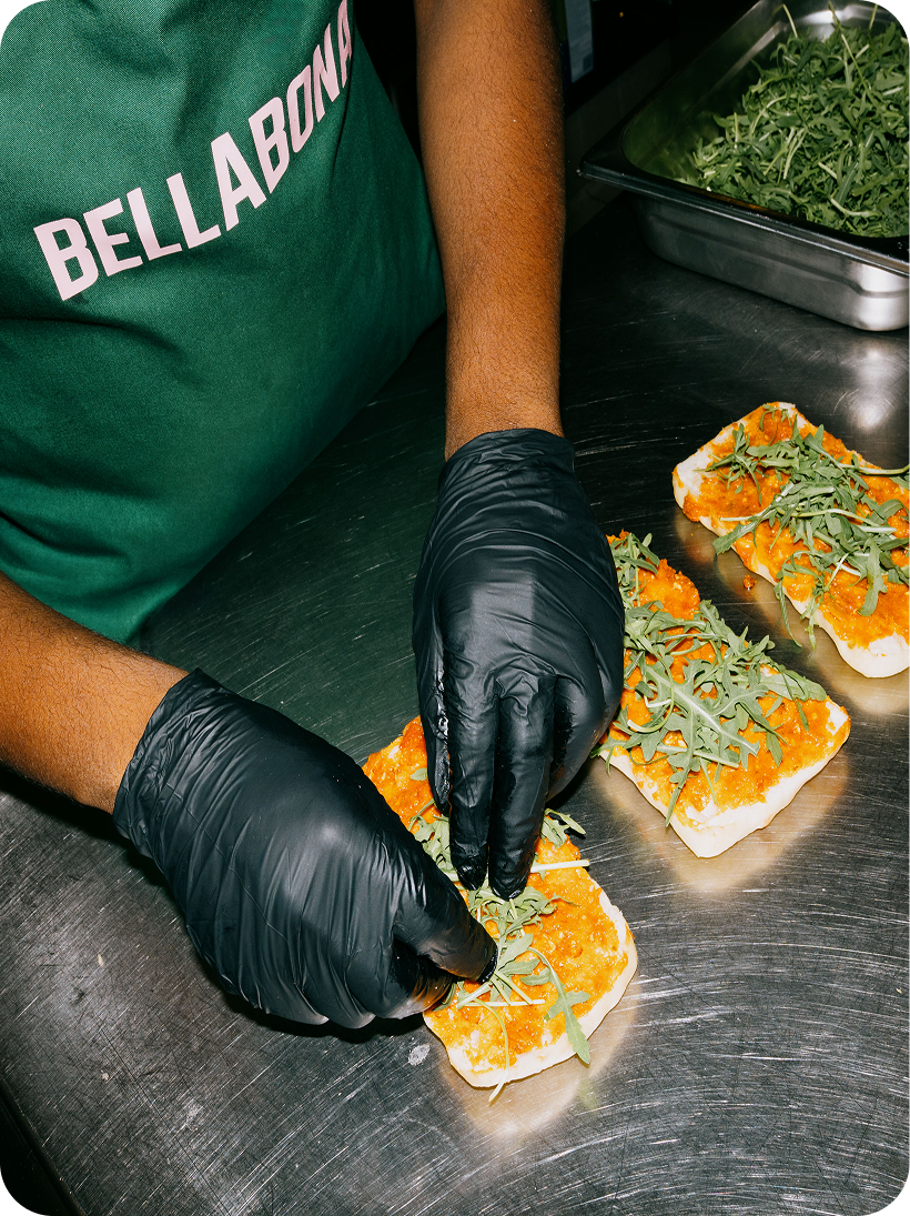 Bella&Bona chef plating a fresh dish in the kitchen