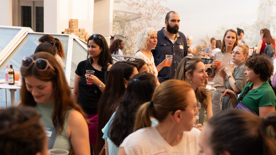 Guests mingling with drinks on a rooftop terrace