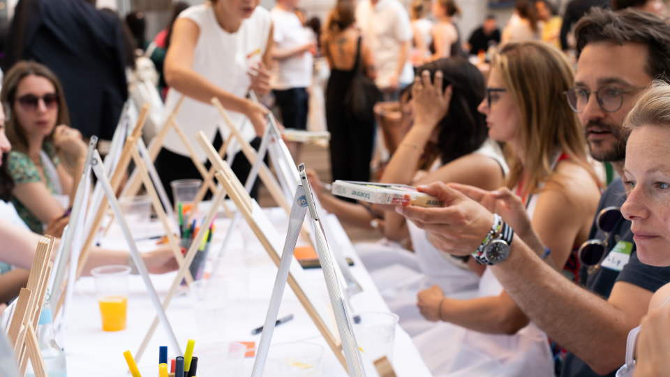 Guests painting at easels during a workshop