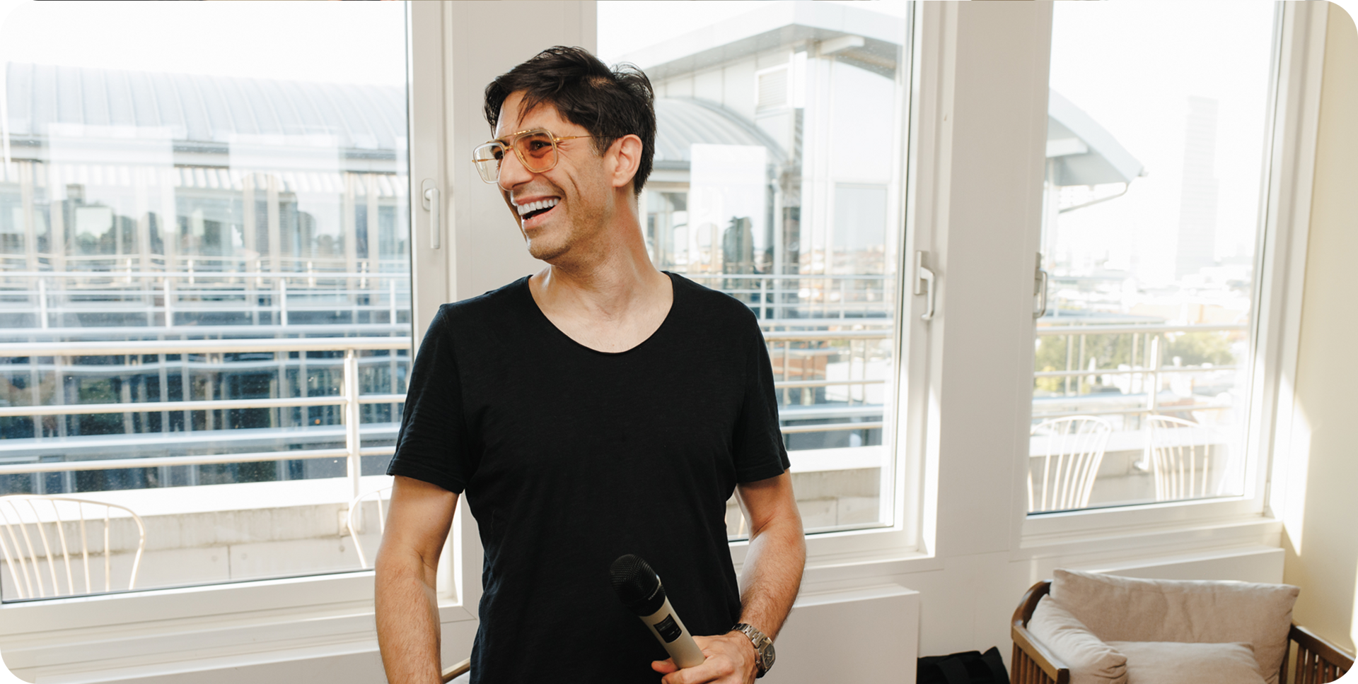 A team member laughing during a rooftop talk