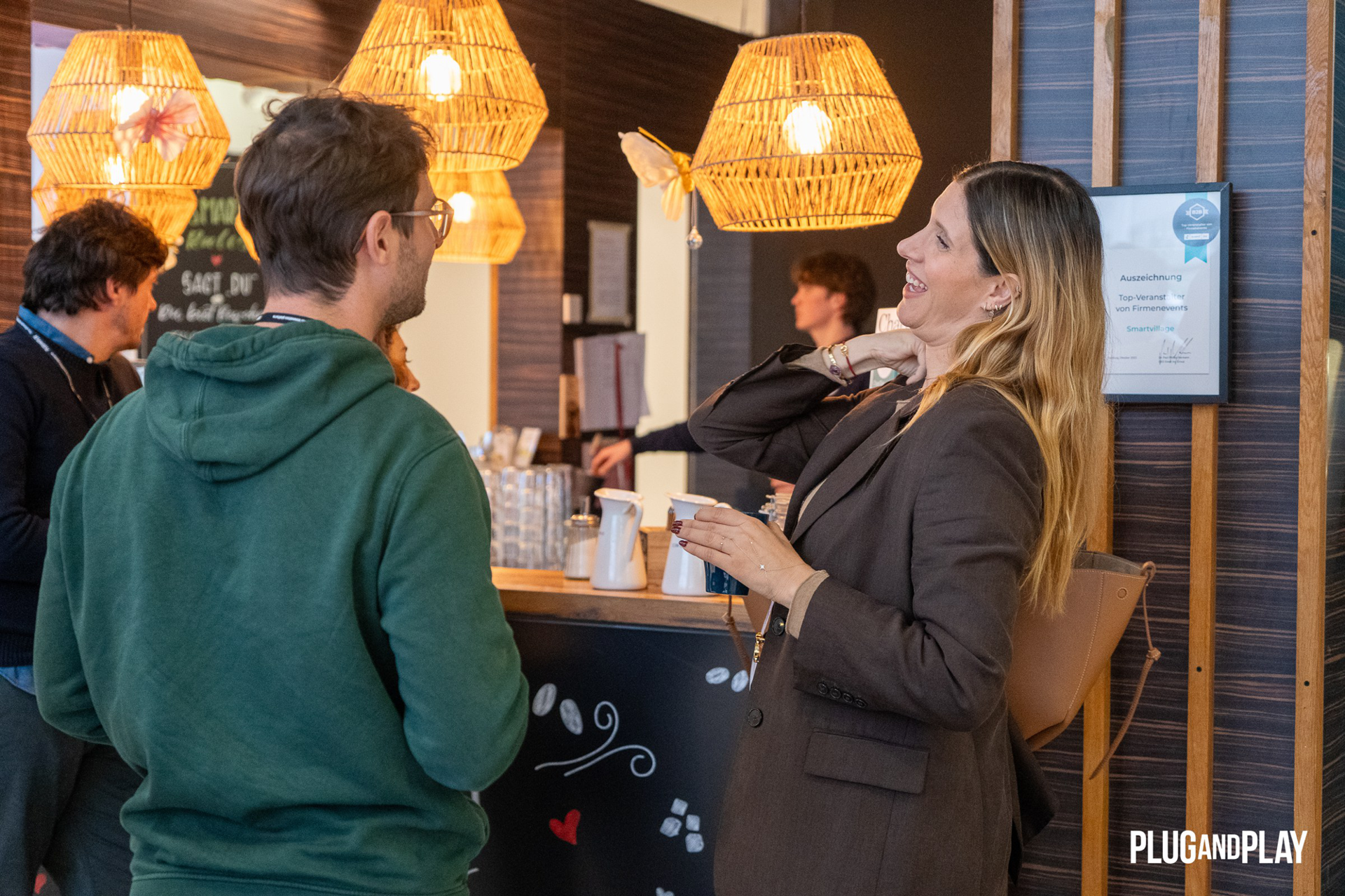 Guests chatting at the coffee bar during the networking break
