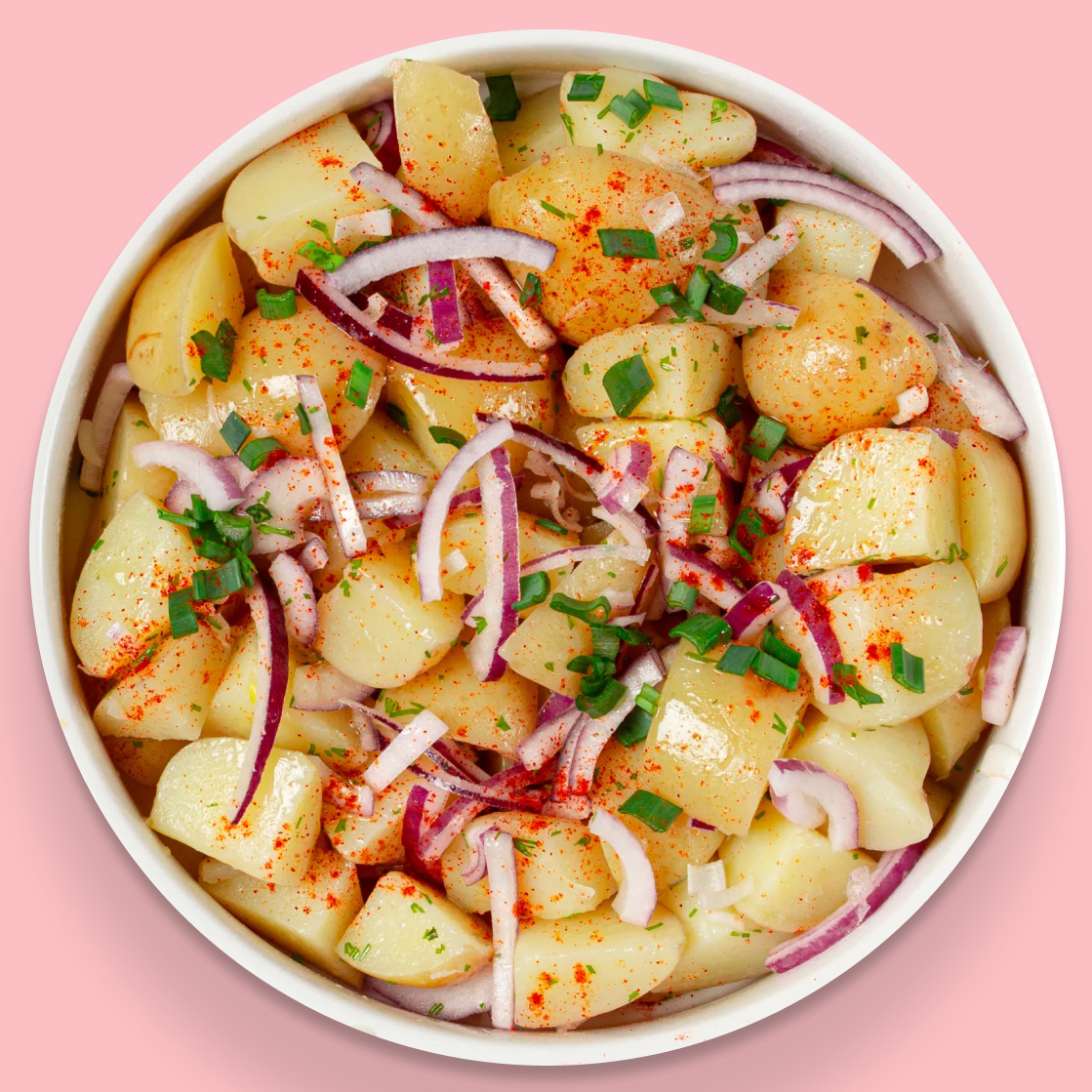 Potato salad topped with red onion and chives
