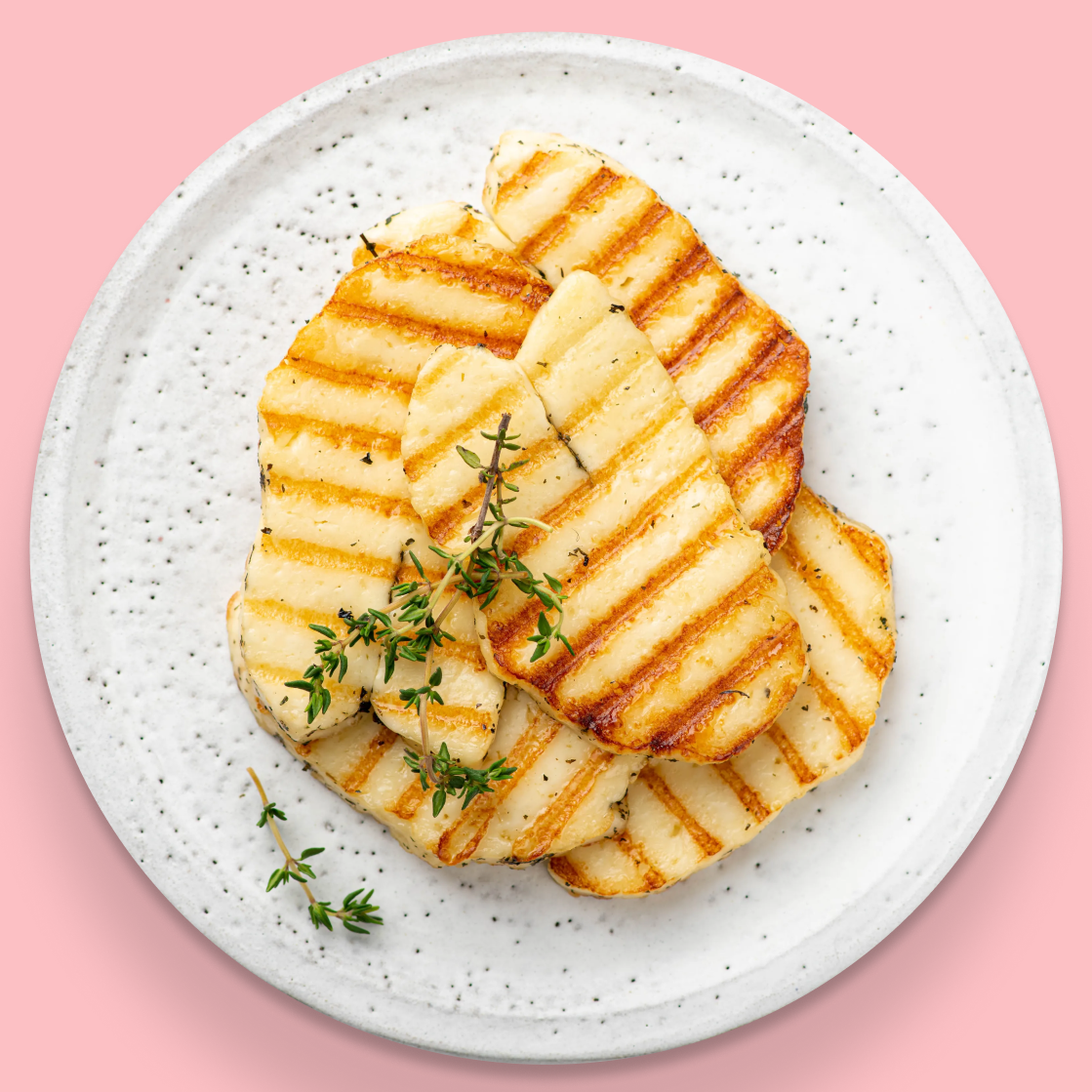 Grilled halloumi with fresh thyme on a plate
