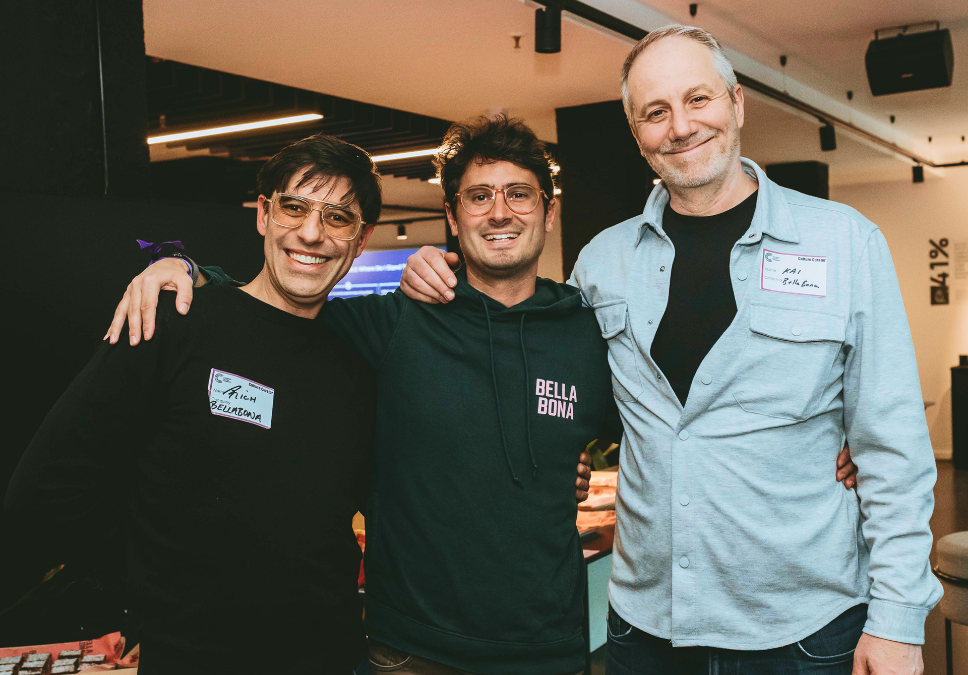 Three Bella&Bona team members smiling together at a team event