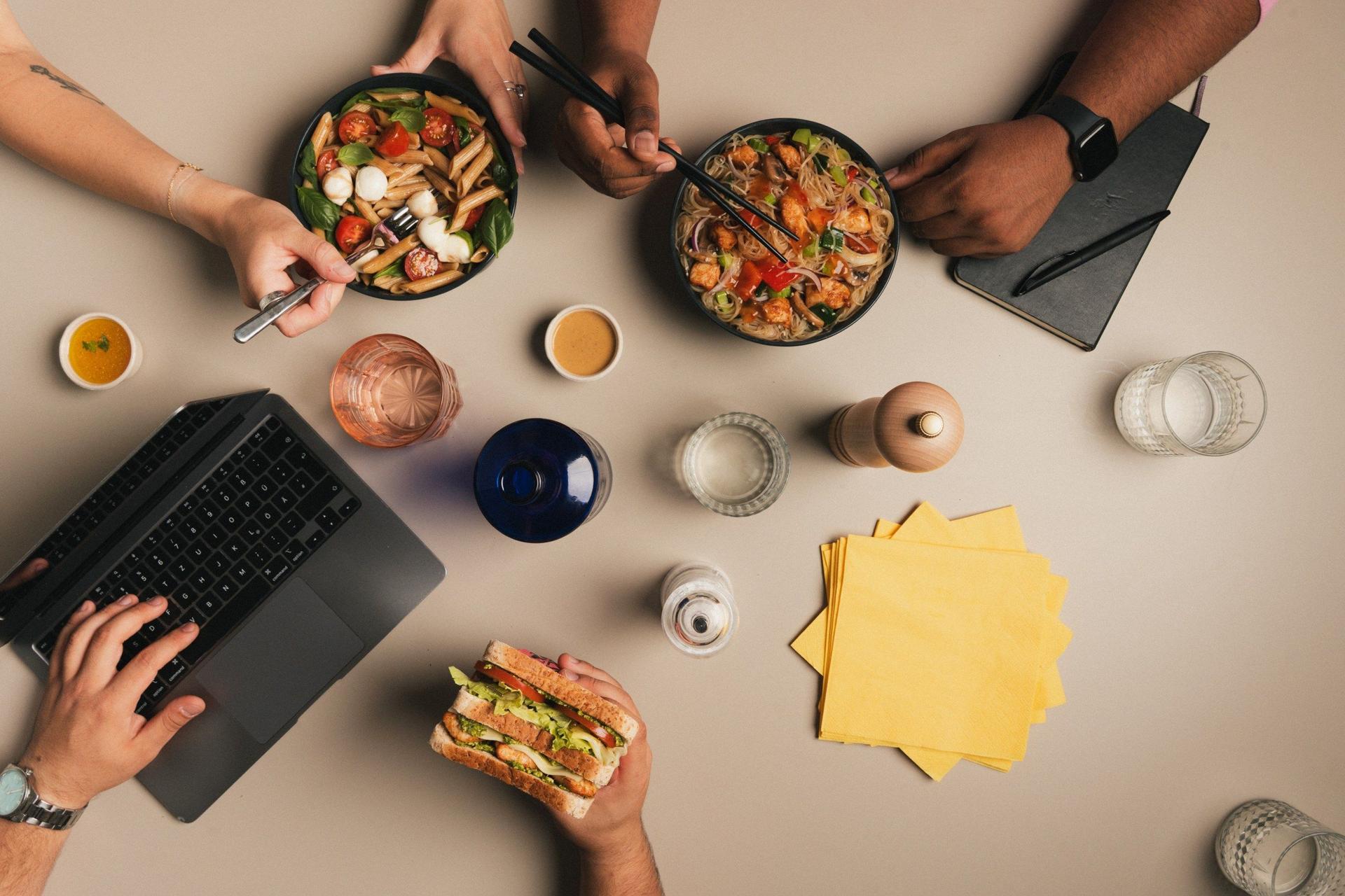 A shared table of fresh office lunch bowls