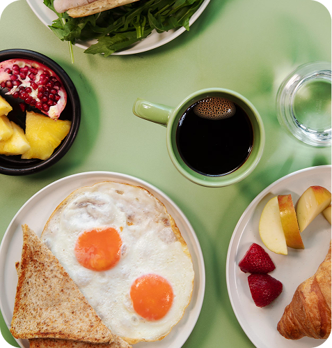 A fresh breakfast spread of eggs, toast, fruit and coffee